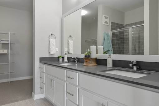 A bathroom with a large mirror and a sink.