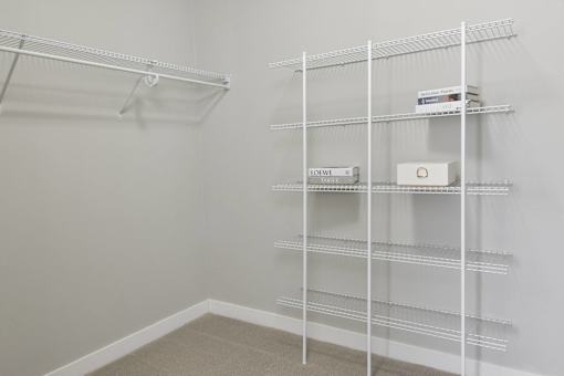 A white shelving unit with boxes on top of it.