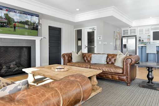 A living room with a fireplace and a large television screen.