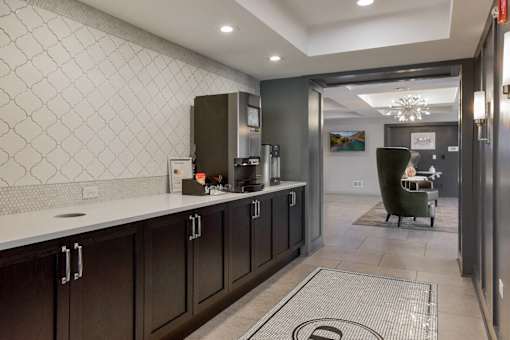 A kitchen with dark wood cabinets and a white countertop.
