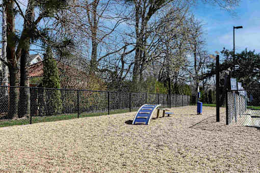 A playground with a slide and a fence.