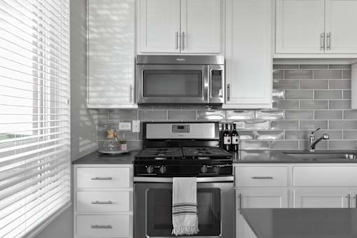 Modern kitchen with white cabinets at Park 205 Park Ridge Apartments