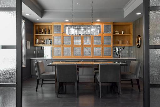 A modern kitchen with a dining table and chairs.
