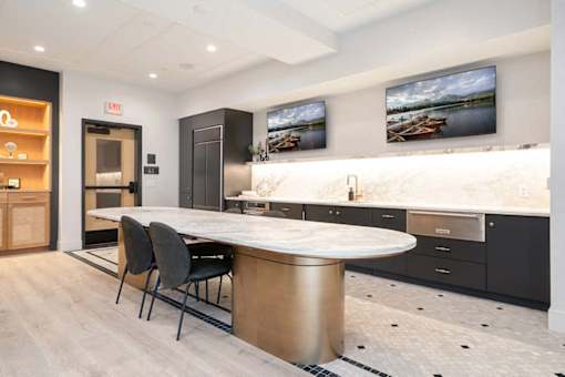 A modern kitchen with a dining table and chairs.