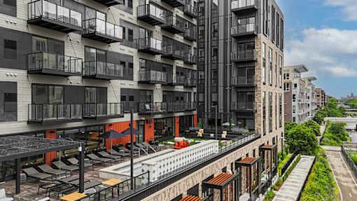 A modern apartment complex with balconies and a pool.