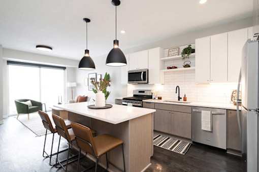 A modern kitchen with a dining table and chairs.