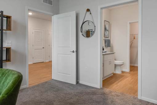 A white door is open to a bathroom.