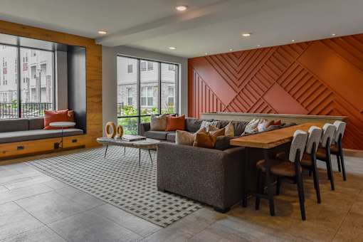 A modern living room with a wooden accent wall and a grey sofa.