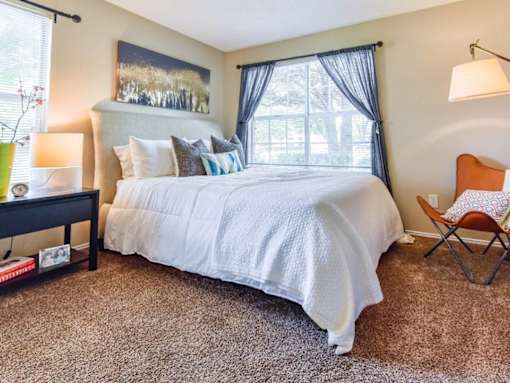 Spacious model bedroom with neutral décor at Riverset Apartments in Memphis, TN.