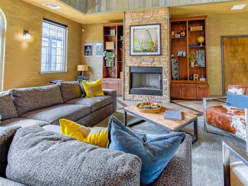 Resident lounge with a fireplace and artwork at Riverset Apartments in Memphis, TN.