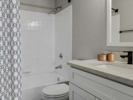 Bright and open bathroom with shower, tub and sink at Riverset Apartments waterfront apartments in Memphis, TN.