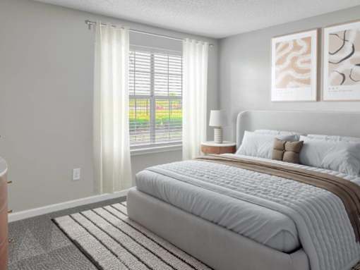 Bedroom with large bed window at Riverset Apartments for rent Memphis, TN.