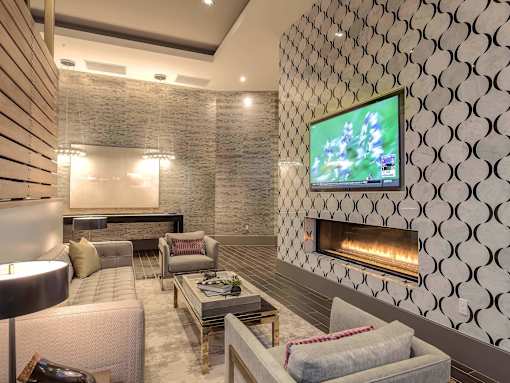 A modern living room with a television and a fireplace.