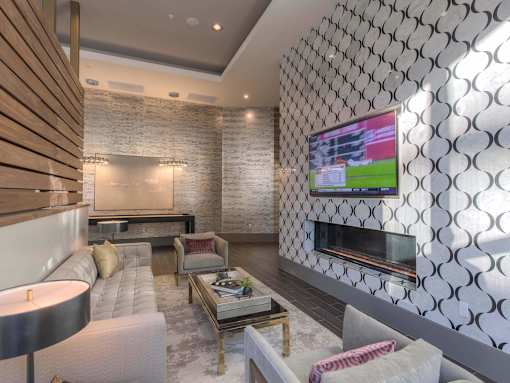 A modern living room with a television and a fireplace.