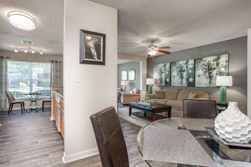 A living room with a brown chair and a grey rug.