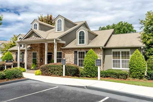 A large house with a driveway in front.