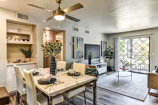 A dining room with a table set for four.