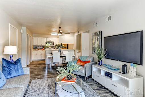A living room with a couch, a coffee table, and a television.