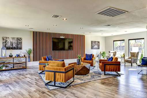 A living room with a wooden floor and furniture.