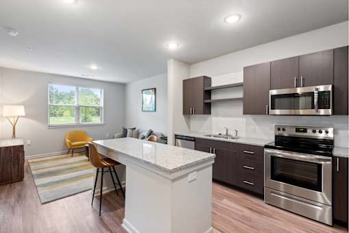Well-appointed kitchen with granite countertops, island and stainless steel appliances