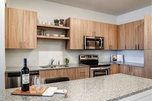 A modern kitchen with stainless steel appliances and wood cabinets