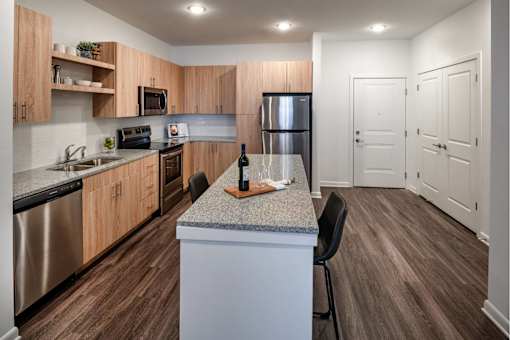 A  modern kitchen with wooden cabinets and granite countertops