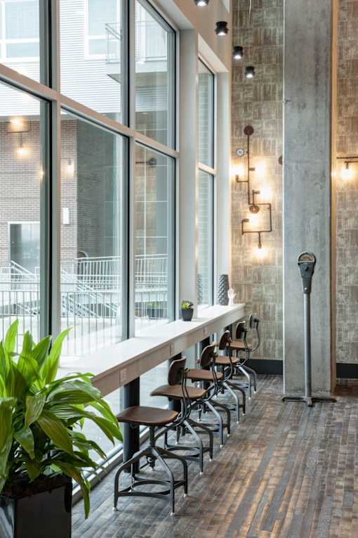 A long table with chairs is in front of a window.