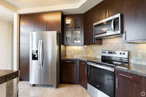 A kitchen with a stainless steel refrigerator and oven.