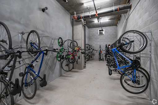 A bike shop with many bikes hanging on the wall.