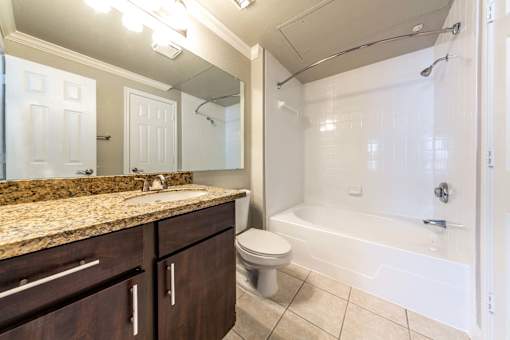 A bathroom with a toilet, sink, and bathtub.