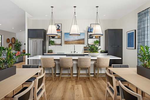 A modern kitchen with a dining table and chairs.