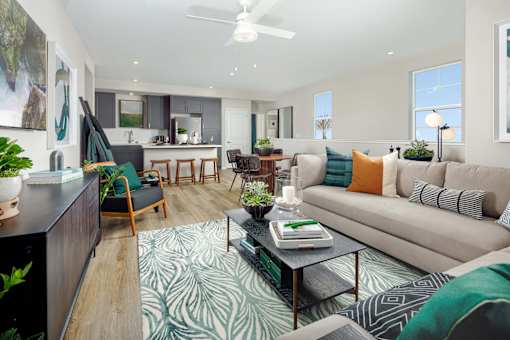A living room with a couch, chairs, and a coffee table.