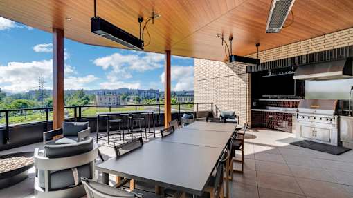 A modern outdoor dining area with a view of the city.