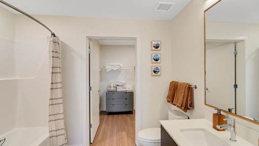 A bathroom with a towel hanging on the towel rack.