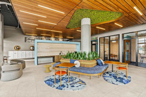 A modern living room with a green plant on the ceiling.