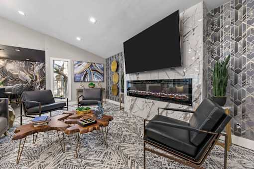 A living room with a fireplace and a large painting on the wall.