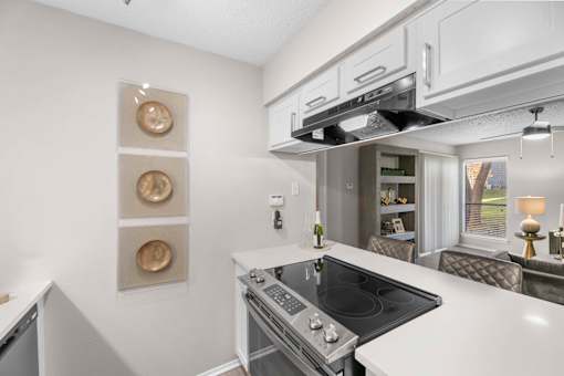 A modern kitchen with a stove top oven and a range hood.