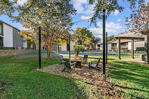 A park area with benches and trees.