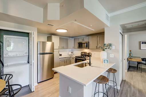A modern kitchen with stainless steel appliances and a central island.