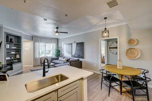 A modern kitchen with a dining table and chairs.