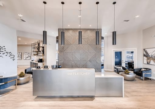 A reception area with a large desk and a wall with a black and white pattern.