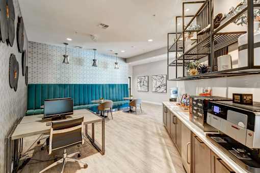 A modern kitchen with a blue backsplash and wooden floors.