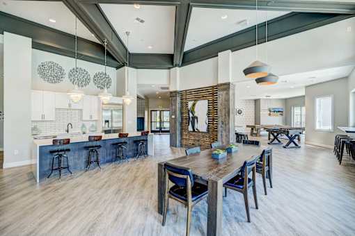 A modern kitchen with a bar and dining area.