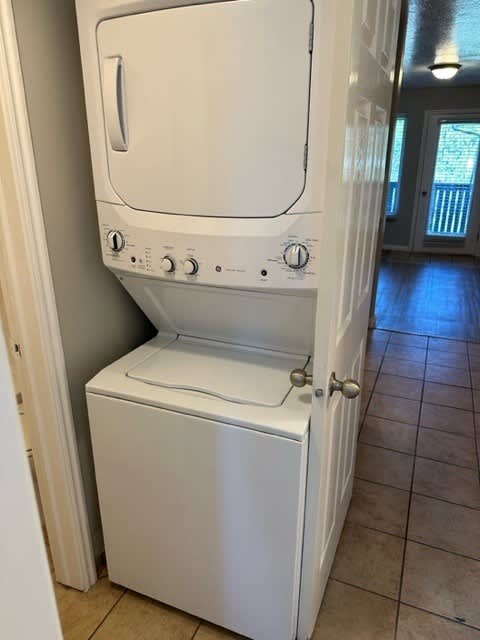A white dishwasher is sitting in a kitchen.