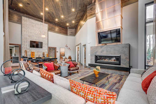 A modern living room with a fireplace and a television.