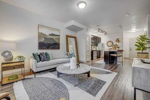 A living room with a grey sofa and a coffee table.