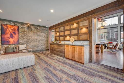 A room with a brick wall and a wooden cabinet.