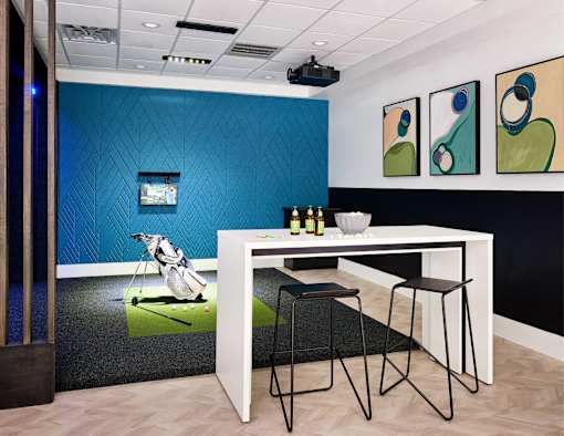 A room with a blue wall and a white table with two chairs.