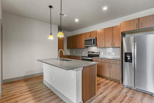 A modern kitchen with wooden cabinets and stainless steel appliances