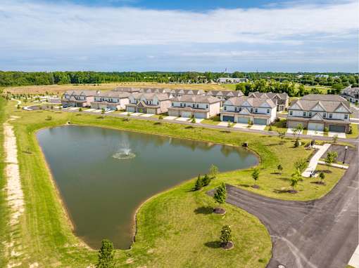 A residential area with a lake and houses.